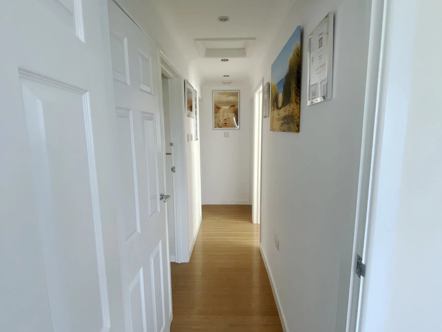 A light and airy hallway showing Hayle Beach over time